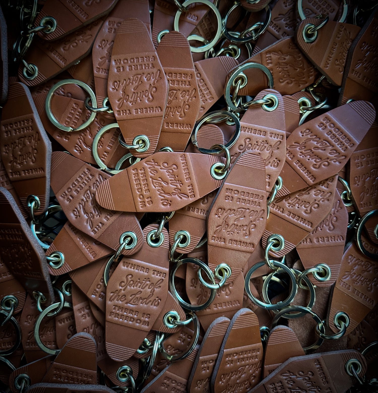 Branded leather key fobs produced by Gunnar & Co. for private label clients, featuring custom debossed logos and solid brass hardware.