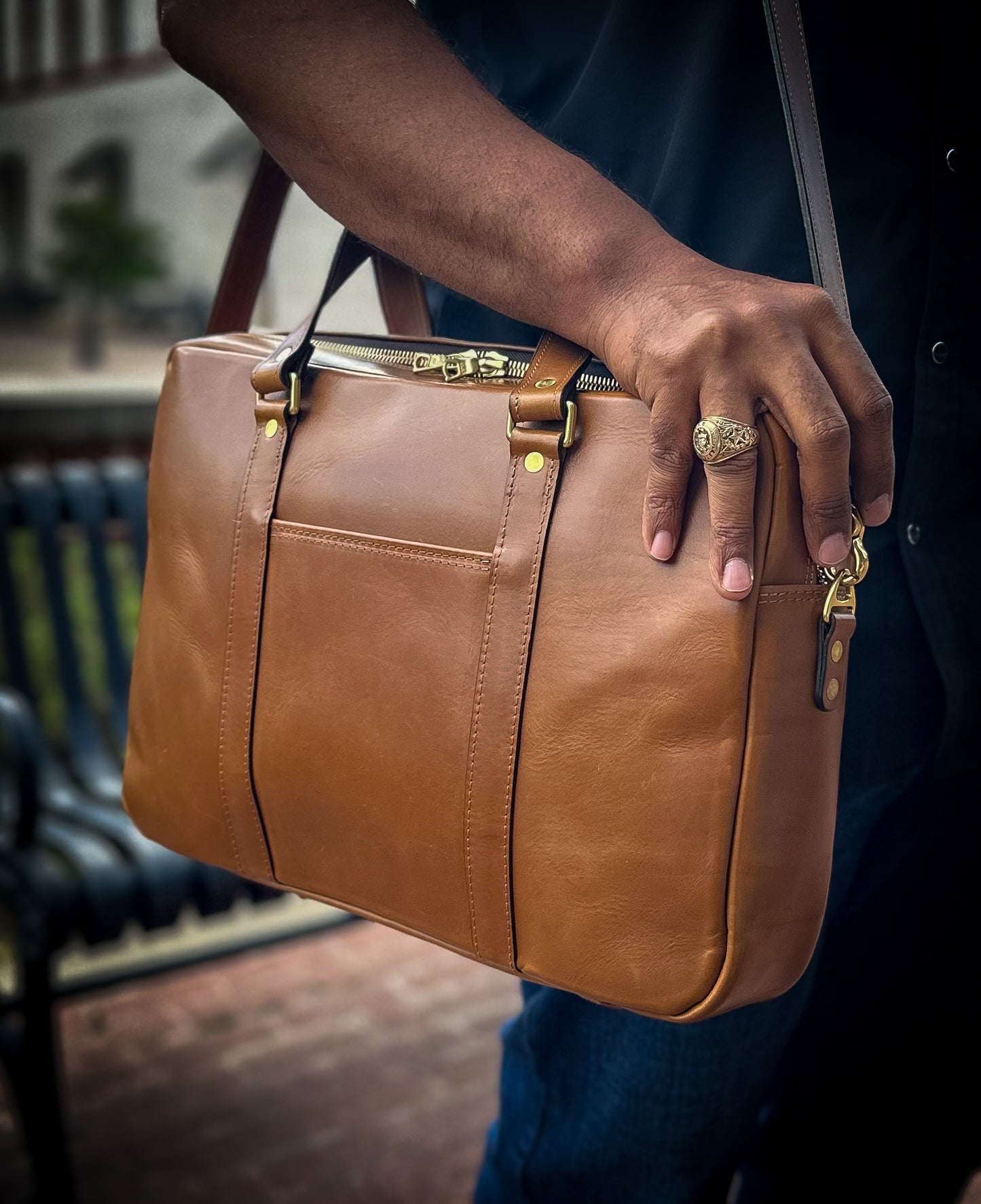 Man carrying handmade leather briefcase outdoors