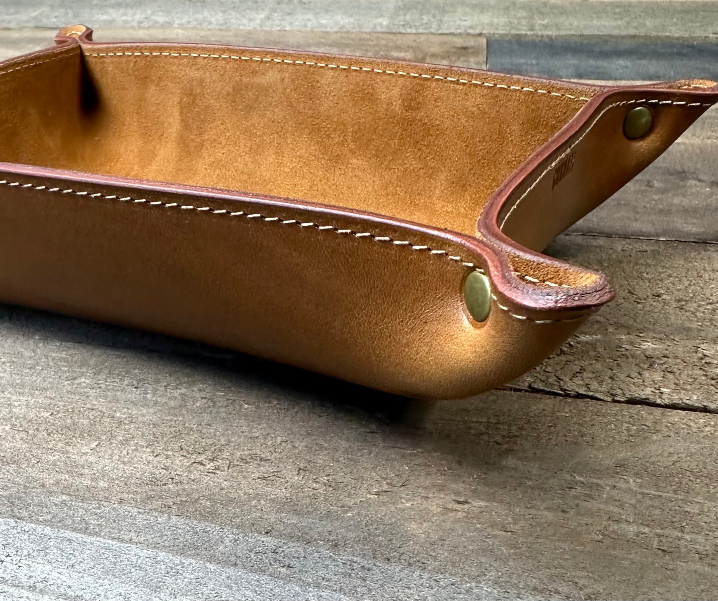 Close-up of corner detail and suede interior of the leather catchall tray, showing stitch precision and craftsmanship.