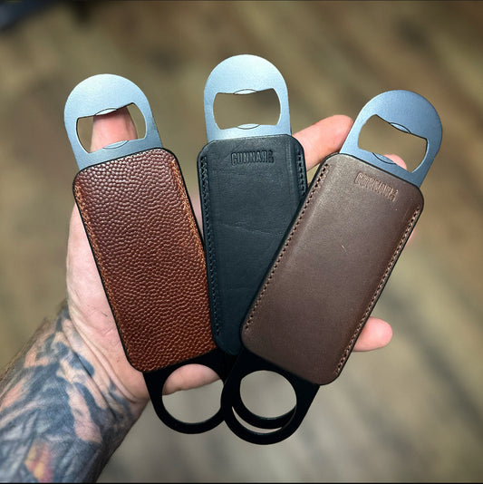Leather wrapped stainless steel bottle opener, handcrafted in Texas.