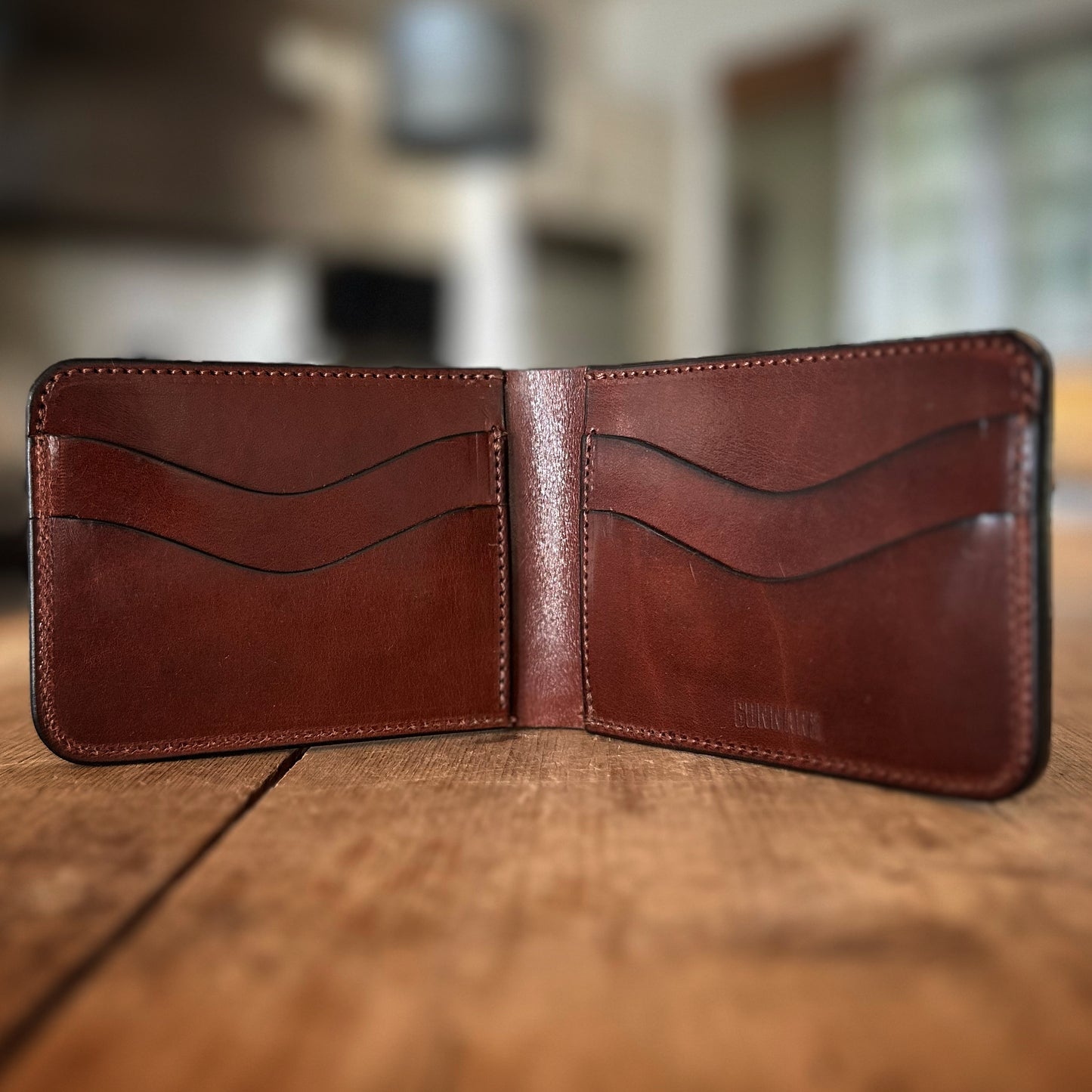 Open leather billfold showing cash pocket and card slots – The Booker Wallet