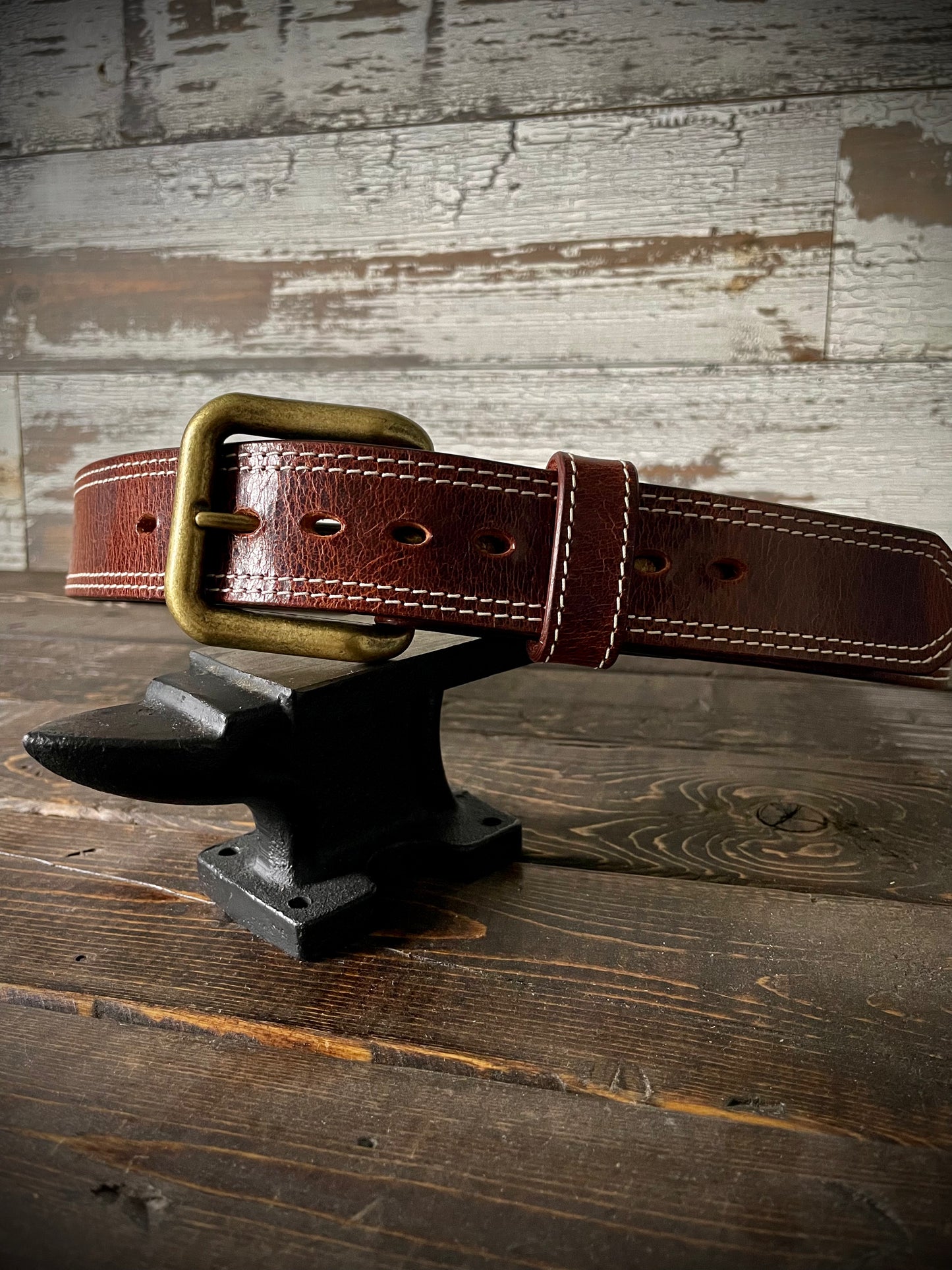 Front view of leather belt showing thick layers and hardware detail